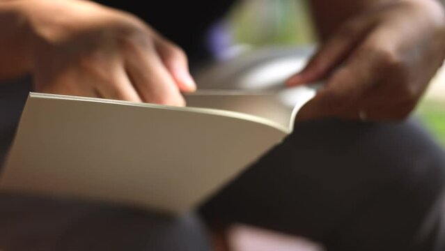 woman's hands making a book in her studio
