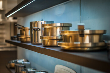 shining copper pots and pans on open shelves
