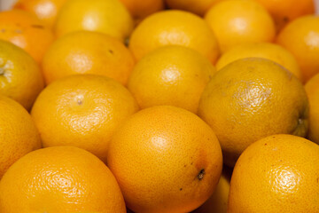 A bunch of yellow grapefruits close-up.