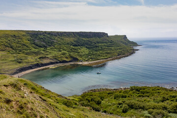 Sail boat moored in Chapman's Pool viewed from Egmont Point on the Dorset stretch of the South West Coast Path
