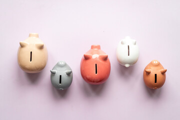 Many piggy bank - different types of currency saving and investments