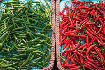 green peppers and red peppers in the super market selling a variety of fresh food.