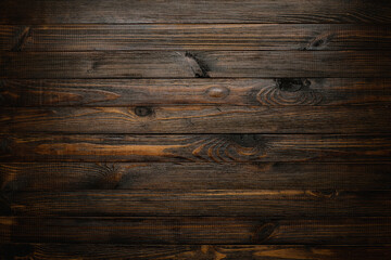 Fond de table en bois teinté foncé, vue de dessus de texture de planches de bois rustiques.