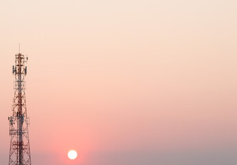 Telecommunication tower silhouette during sunset with pastel sky background. Concept of digital...