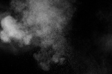White powder explosion on black background. Abstract dust overlay texture. Freeze motion of particles.