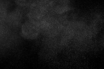 White powder explosion on black background. Abstract dust overlay texture. Freeze motion of particles.