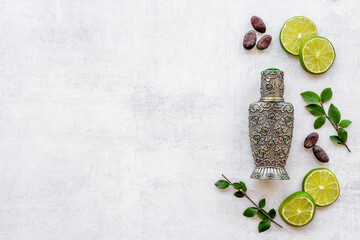 Silver bottle of arabian oud perfume with ingredients