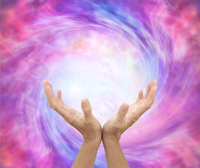 Healer sensing awesome vortexing energy field - female hands reaching into a spiralling pink energy field with space for message
