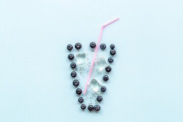 Concept of berries as cocktail or juice glass with cocktail tube