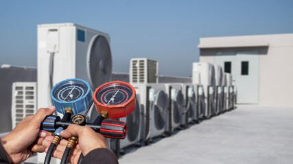 Air conditioner technician checks the operation of industrial air conditioners.	