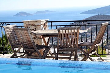 Stunning sea view and wooden seating in the garden in a villa in Antalya's 'Kaş' district