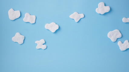 Puffy white clouds on a light blue background. Creative minimal. Copy text. Happy Easter, Baby shower.