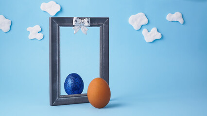 Cute egg bunny in a mirror. Creative Easter concept. Easter egg with cotton wool ears and tail....