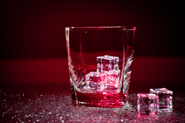 Glass transparent glass with ice cubes for cooling drinks.