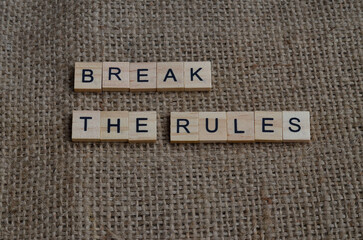 break the rules text on wooden square, motivation and business quote