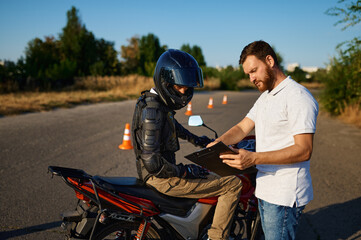 Male student and instructor, motorcycle school