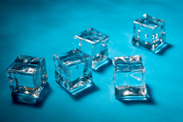 Clear ice cubes for cooling drinks on a blue background.