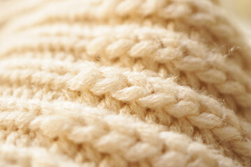 closeup beige knitted woolen fabric texture background