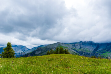 A picturesque landscape view of the French Alps mountains on a cloudy summer day (Valberg, Alpes-Maritimes, France)