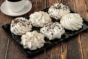 meringue cookies or beze cookies with candy and chocolate - obrazy, fototapety, plakaty
