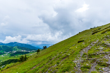 A picturesque landscape view of the French Alps mountains on a cloudy summer day (Valberg, Alpes-Maritimes, France)