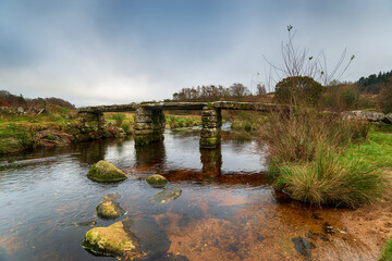 The ancient clapper bridge crossing the East Dart River at Postbridge