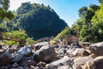 traditional bamboo bridge for crossing river at forest at morning from flat angle