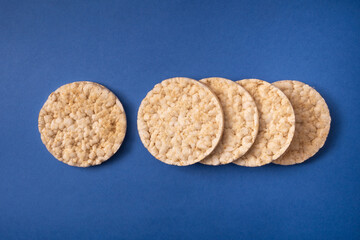 round rice cakes isolated on blue background. gluten free