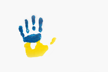 Imprint of child's hand with colors of Ukrainian flag isolated on white background. Copy space