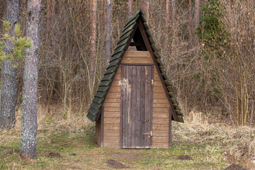 Fototapeta premium Wooden toilet in the woods. Outhouse in the wood.
