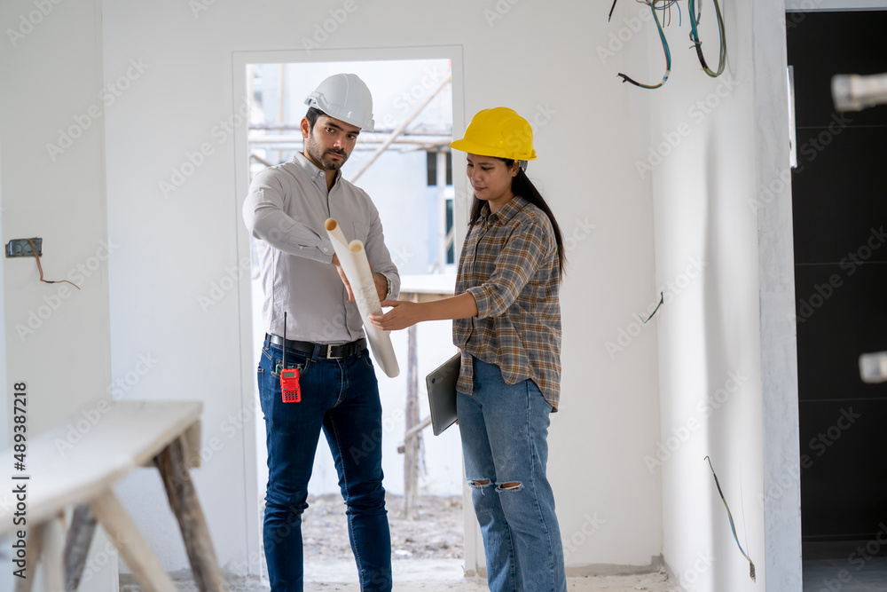 Poster Architect,Foreman and worker discussing in building construction site in construction site,Construction residential new house in progress at building site.