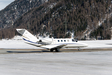 A private jet landing at the Engadine St Moritz airport	