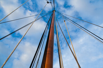 Mast of a sailing yacht without a sail. View from below.