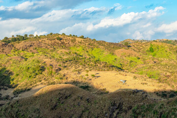 mountain covered with green forests and bright blue sky at afternoon from flat angle