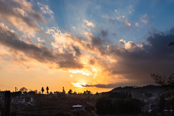 sunset colorful dramatic sky with mountain village at evening from flat angle
