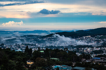 downtown city view with dramatic cloudy sky at evening from mountain top