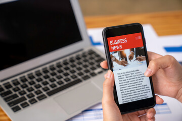business woman using a mobile phone in the office to update financial investment news and analysis of business stocks via smartphone