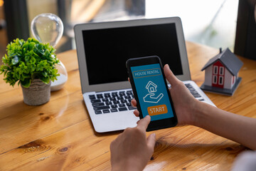business woman using mobile phone to rent a house through a smartphone application