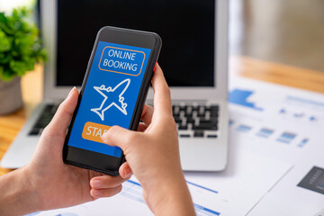 business woman using a mobile phone in the office to book a plane ticket online via smartphone