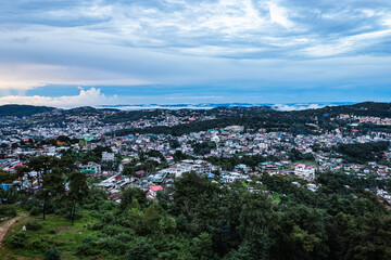 downtown city view with dramatic cloudy sky at evening from mountain top