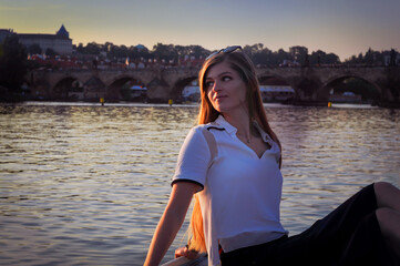 Fototapeta premium portrait of a girl in a golden hour on Vltava River
