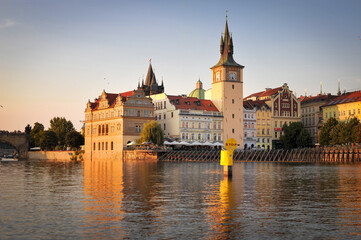 prague street and muzeum Bedricha Smetany view from Vltava river at sunset golden hour