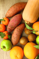 Various healthy fruit and vegetable on wooden background. Top view.