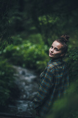 portrait of a girl wearing a flannel checkered shirt in nature