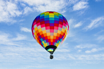 Colorful hot air balloon, flying over a blue sky