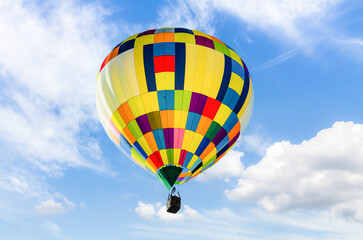 Colorful hot air balloon, flying over a blue sky