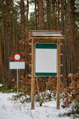 Empty boards and signs set by the forest road.