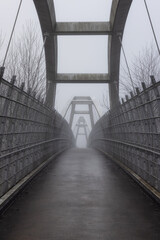 Pedestrian bridge over the Trans-Canada Highway 1 during a winter foggy morning. Surrey, Greater Vancouver, British Columbia, Canada.
