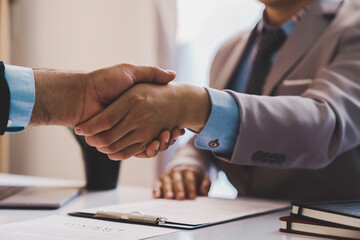 Employer interviewing for a job or head of HR is shaking the hand of male job applicant greeting with the successful interview, HR handshake man candidate congratulating with employment, welcome work