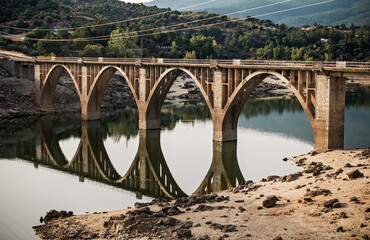 Modern bridge and its reflection over the river